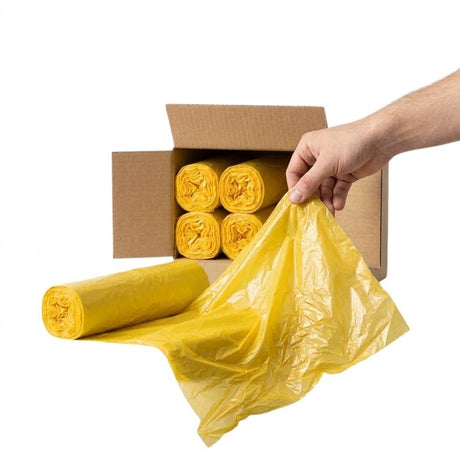 Gele afvalzakken van 60 liter bij een afvalcontainer